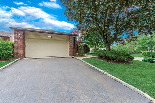 a view of a house with a yard and garage