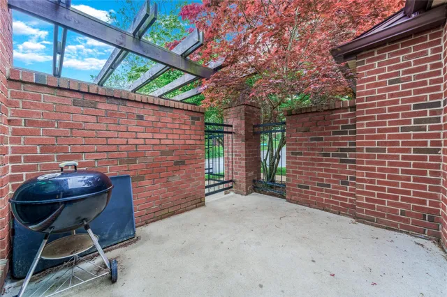 a view of a house with a big yard potted plants and large tree