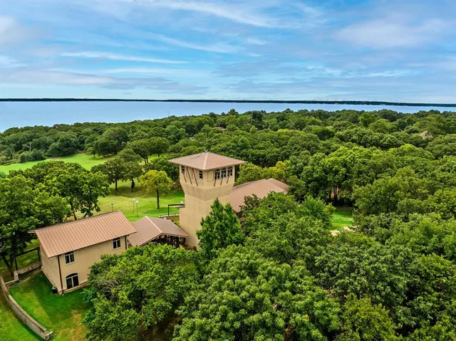 an aerial view of a house with a yard