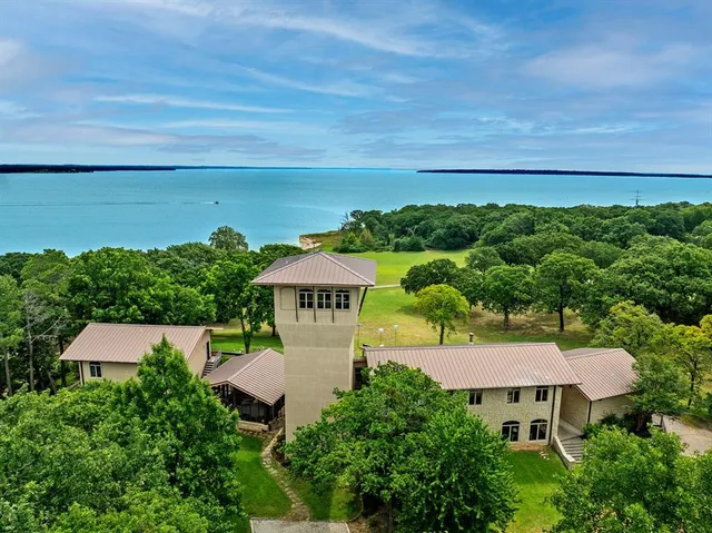 an aerial view of a house with a yard