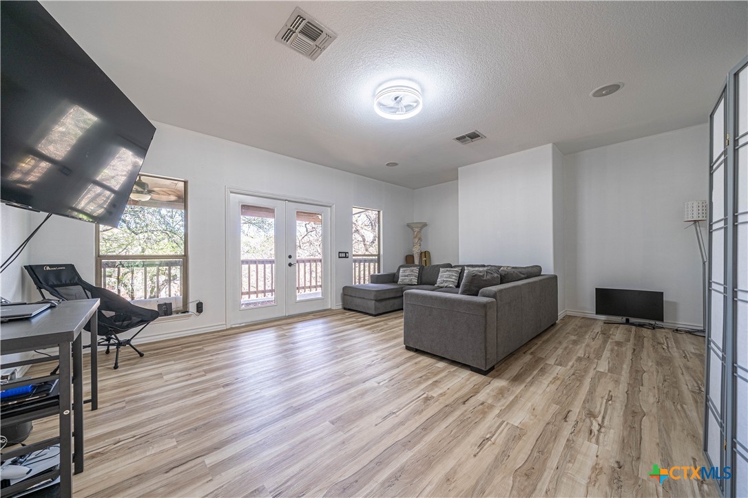519 Long Meadow Spring Branch, TX 78070 - Photo 20 of 33 a living room with furniture and a wooden floor