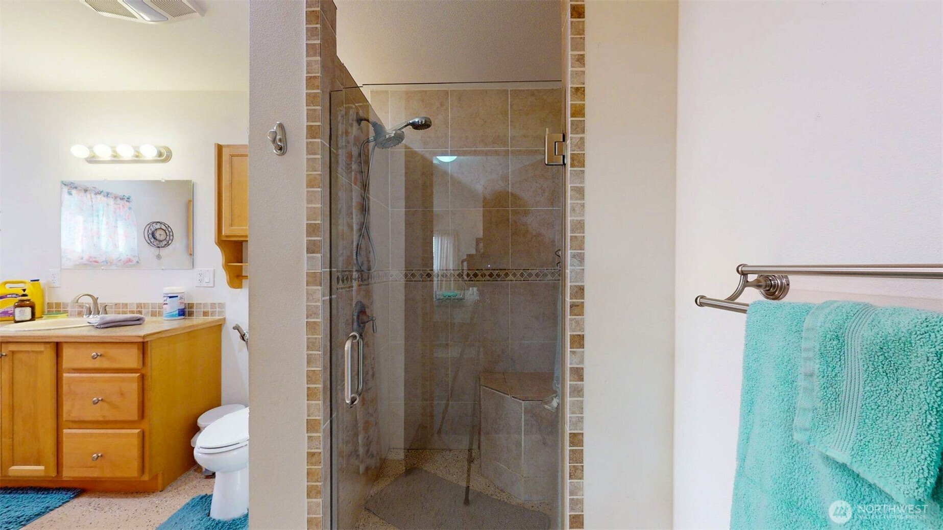 46 Shumway Road Omak, WA 98841 - Photo 19 of 40 a bathroom with a granite countertop shower a sink and toilet