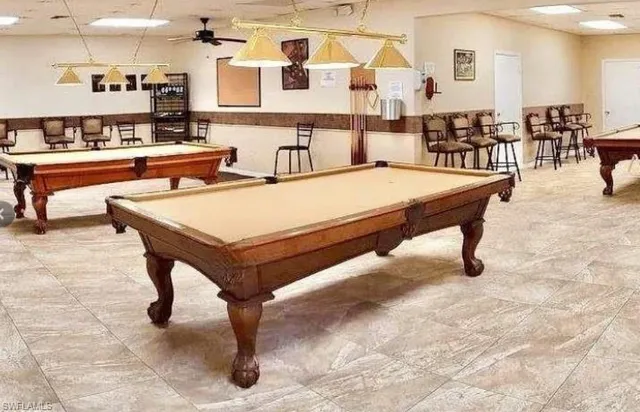 a living room with chairs and a table