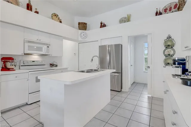 a kitchen with a sink appliances and cabinets