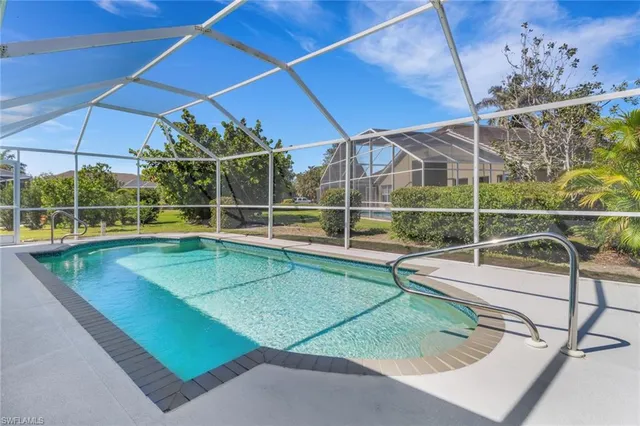 a view of a backyard with a swimming pool
