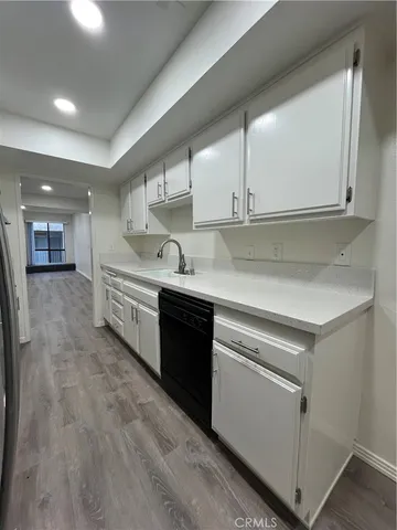 a kitchen with stainless steel appliances granite countertop a sink a stove and a refrigerator