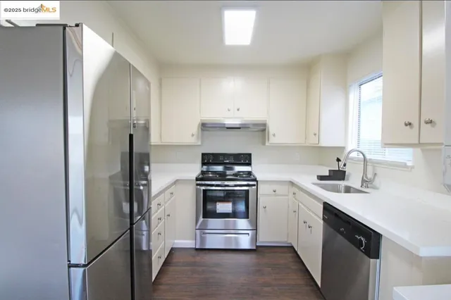 a kitchen with a stove sink and refrigerator