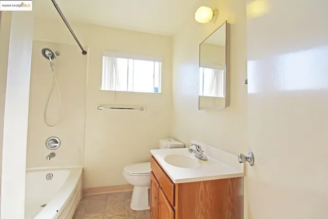 a bathroom with a sink toilet tub and shower