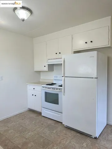 a kitchen with cabinets stainless steel appliances and a counter space