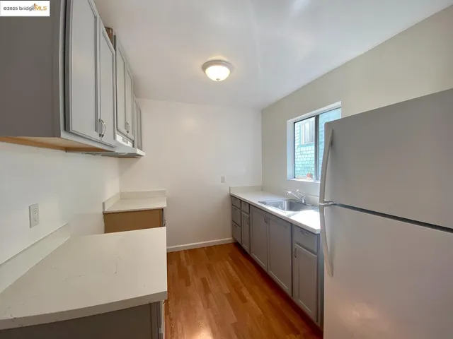 a kitchen with stainless steel appliances a refrigerator and a stove top oven