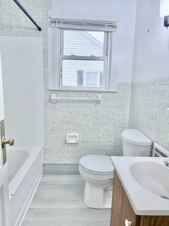 a bathroom with a toilet a sink and bathtub
