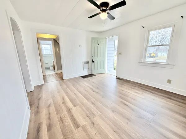a view of a big room with wooden floor and windows in a room