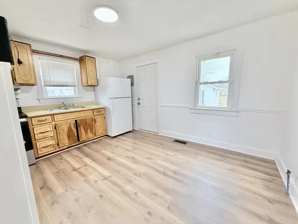 a view of a kitchen with stainless steel appliances granite countertop a sink and a stove top oven