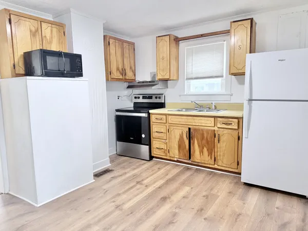 a kitchen with stainless steel appliances a refrigerator sink and microwave