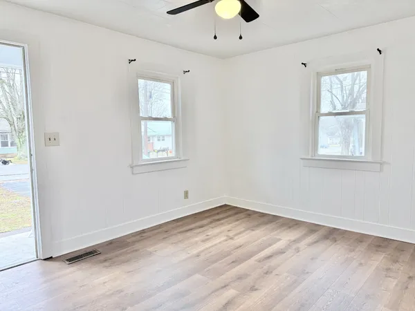 an empty room with windows and closet