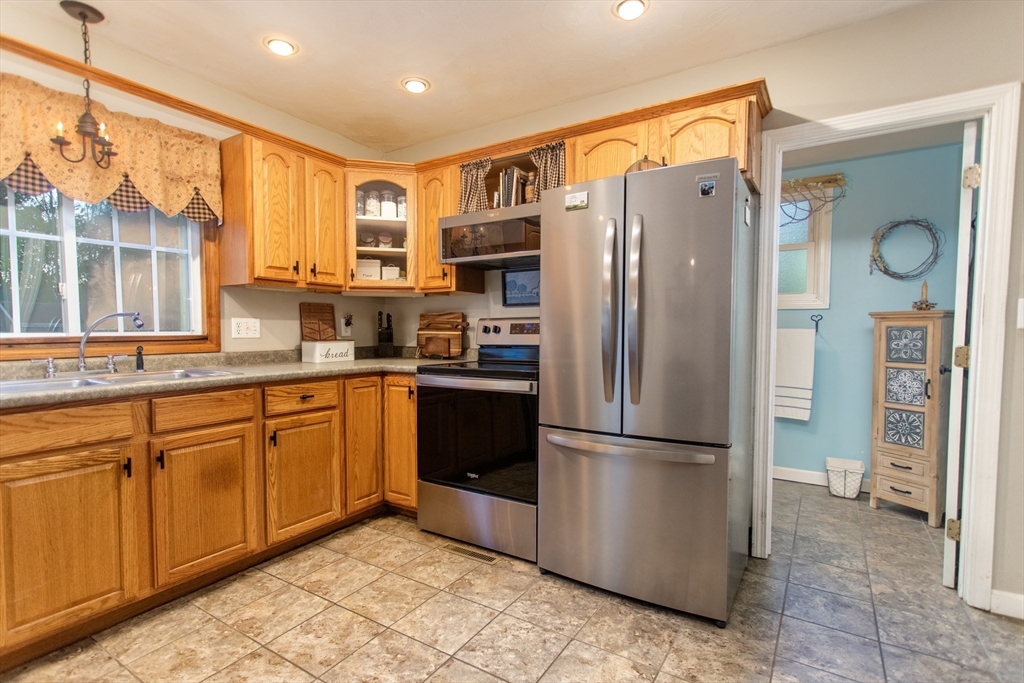 245 R Laurel Street East Bridgewater, MA 02333 - Photo 11 of 37 a kitchen with stainless steel appliances granite countertop a refrigerator and a sink