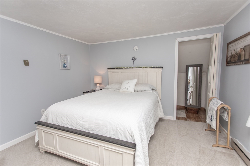 245 R Laurel Street East Bridgewater, MA 02333 - Photo 29 of 37 a bedroom with a bed and a mirror