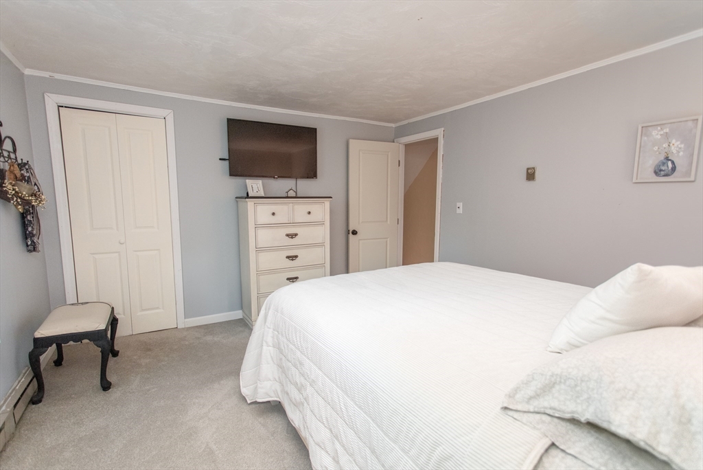 245 R Laurel Street East Bridgewater, MA 02333 - Photo 30 of 37 a bedroom with a bed and a flat screen tv