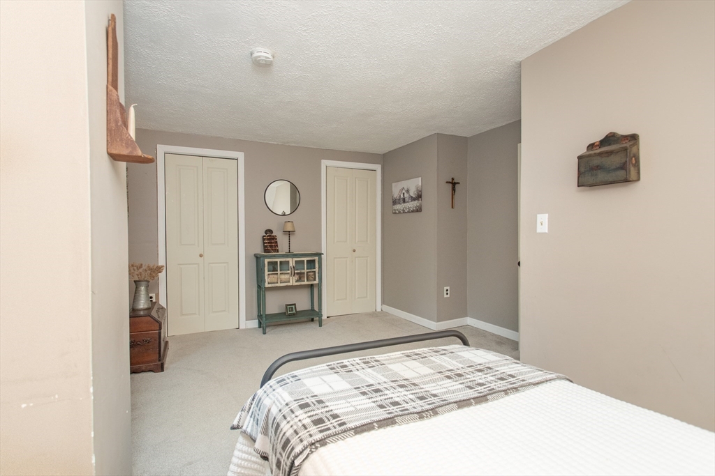 245 R Laurel Street East Bridgewater, MA 02333 - Photo 35 of 37 a bedroom with a bed and a television