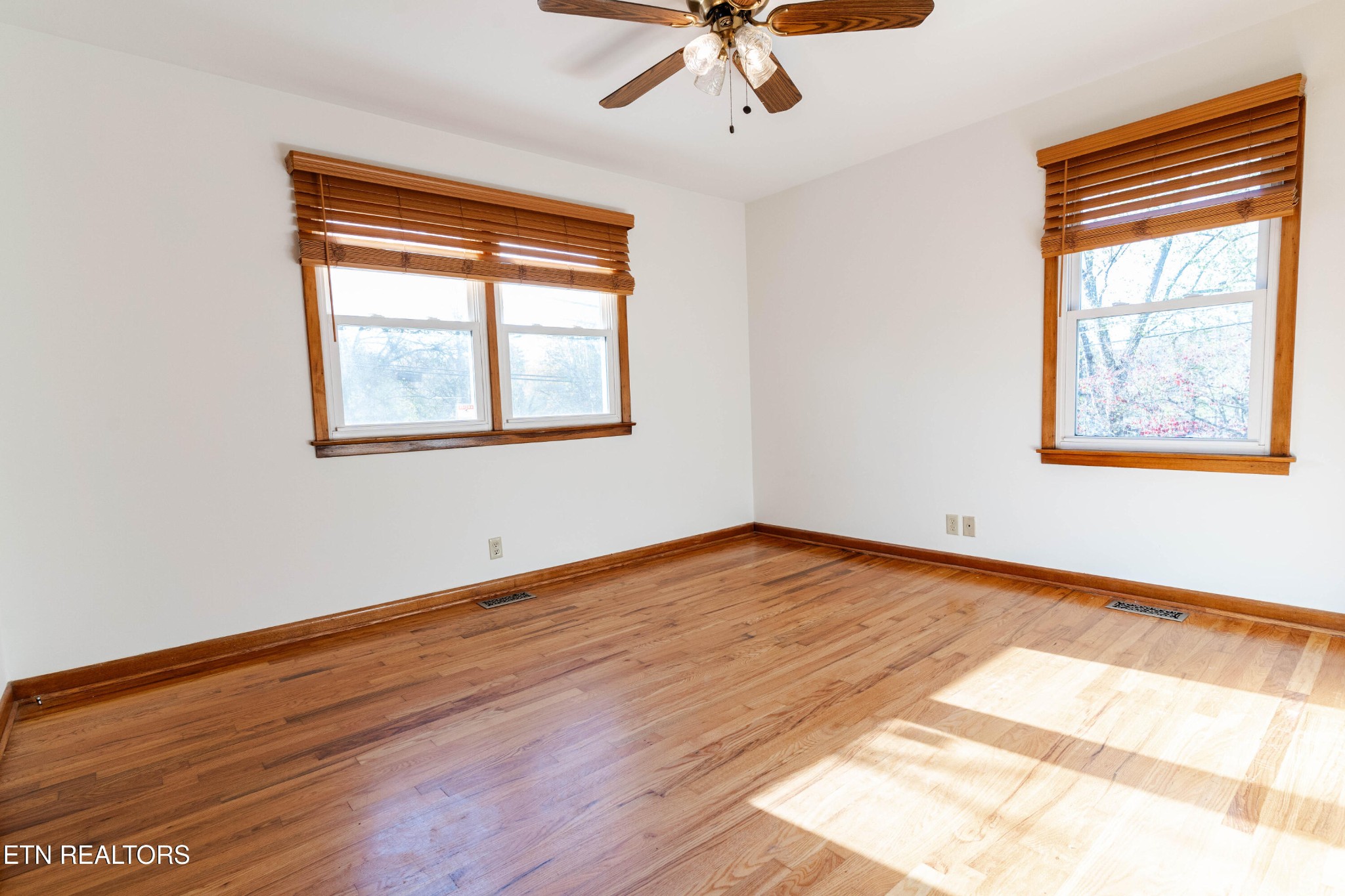 3424 Whittle Springs Road Knoxville, TN 37917 - Photo 11 of 29 a view of an empty room with wooden floor and a window