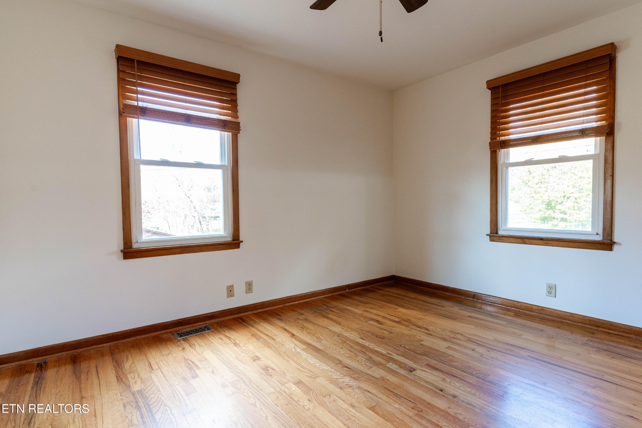 3424 Whittle Springs Road Knoxville, TN 37917 - Photo 12 of 29 a view of an empty room with wooden floor and a window