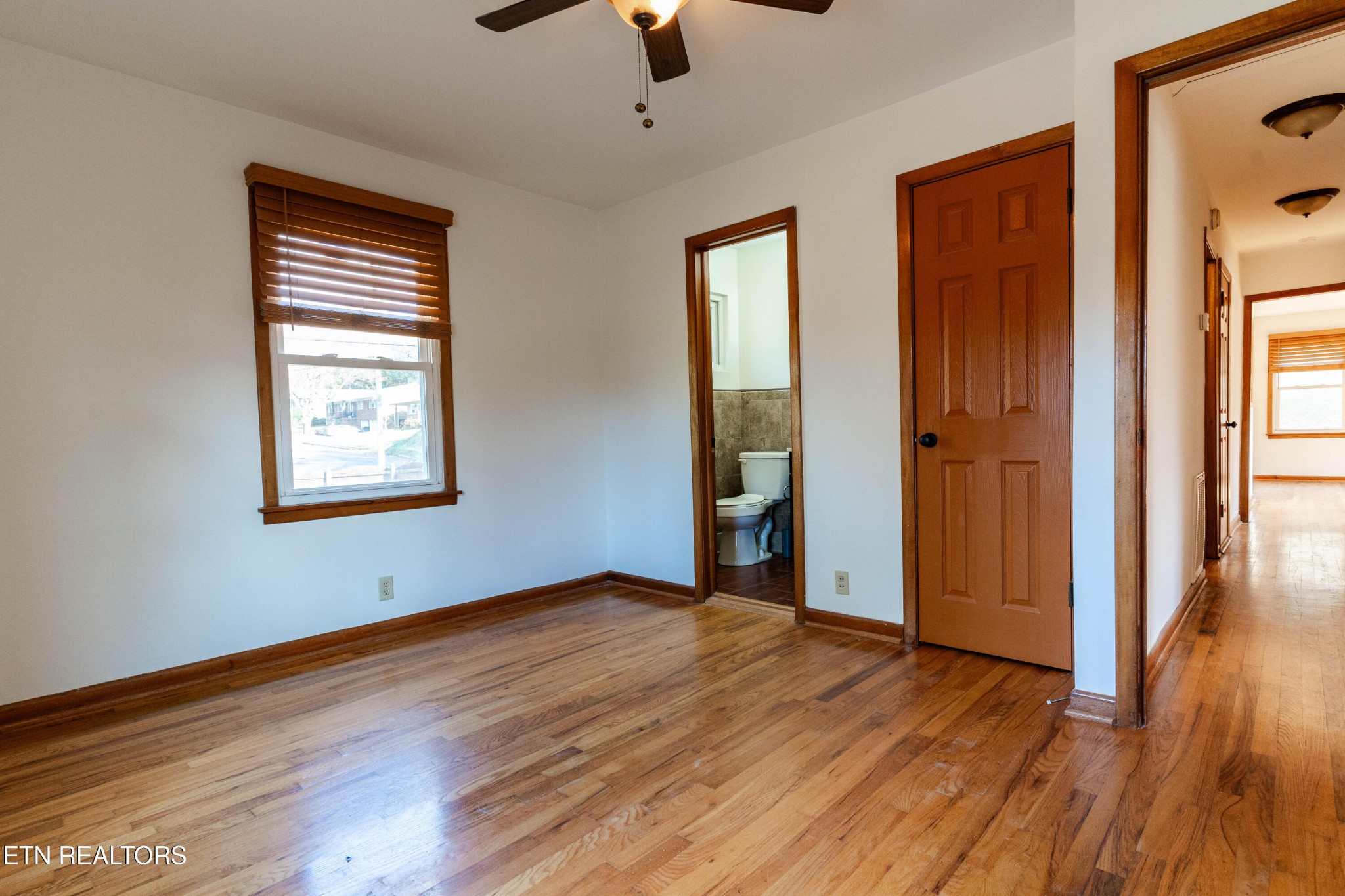 3424 Whittle Springs Road Knoxville, TN 37917 - Photo 13 of 29 wooden floor in an empty room with a window