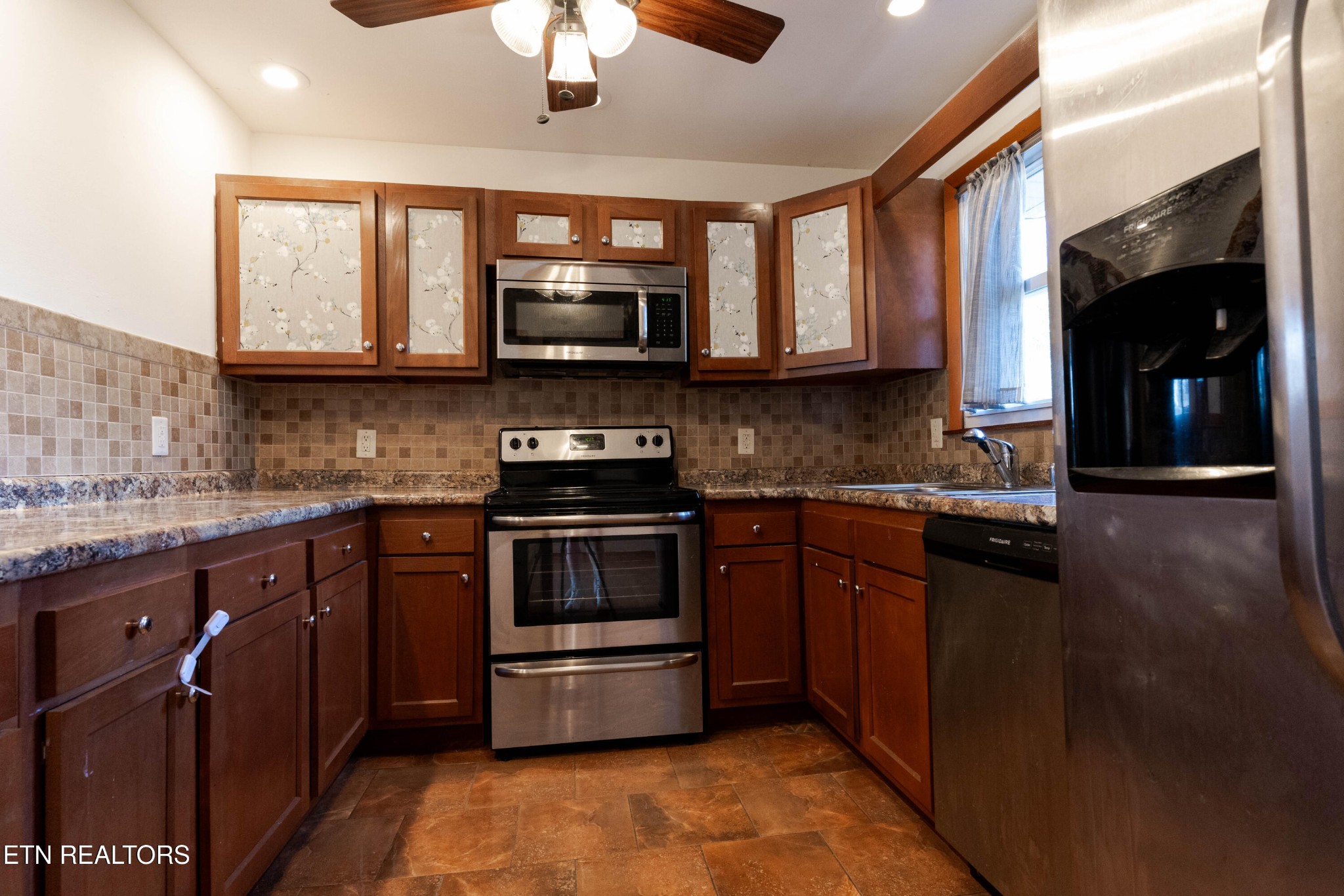 3424 Whittle Springs Road Knoxville, TN 37917 - Photo 14 of 29 a kitchen with stainless steel appliances granite countertop a stove a sink and a microwave