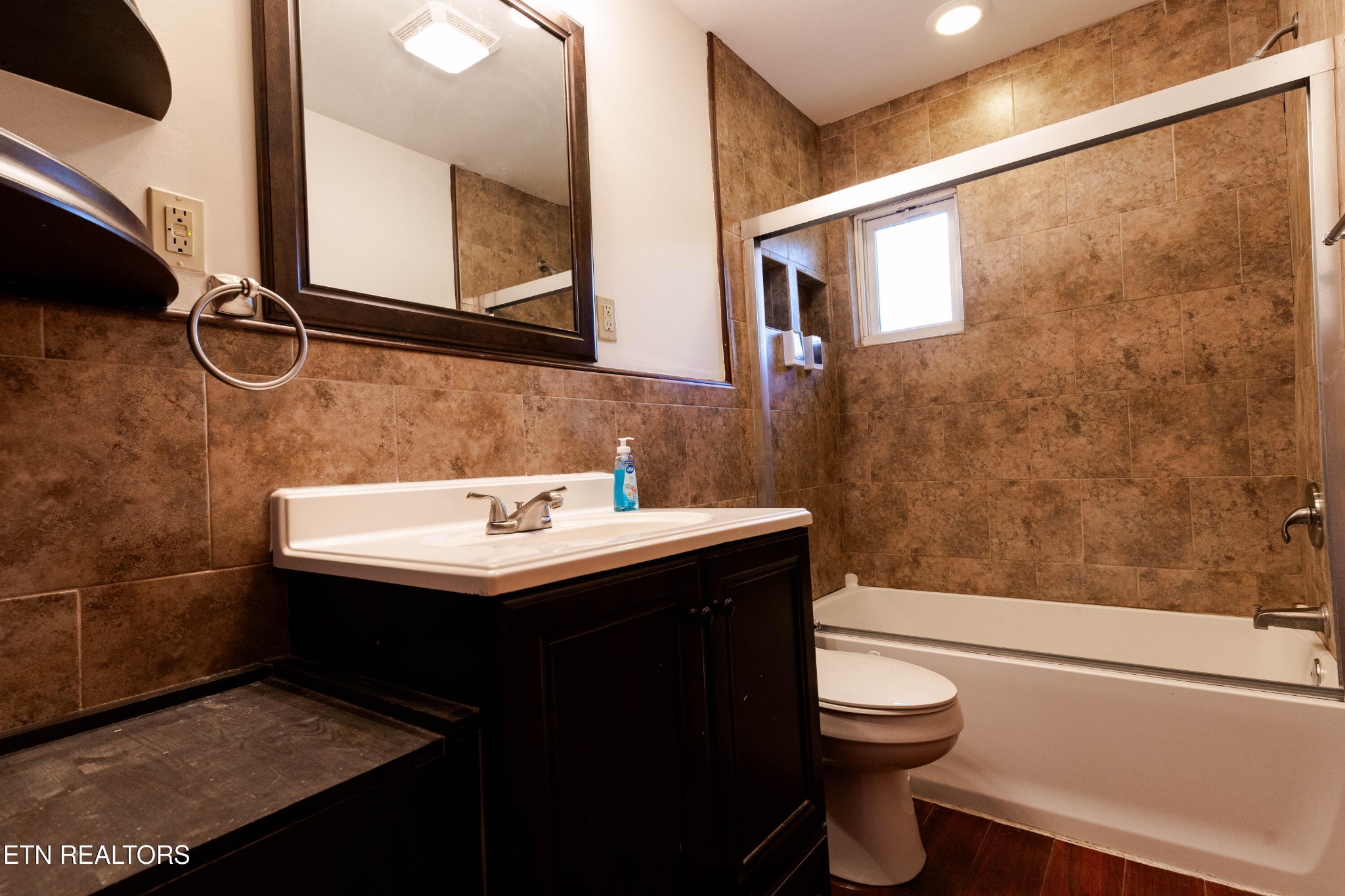 3424 Whittle Springs Road Knoxville, TN 37917 - Photo 16 of 29 a bathroom with a sink a toilet and shower