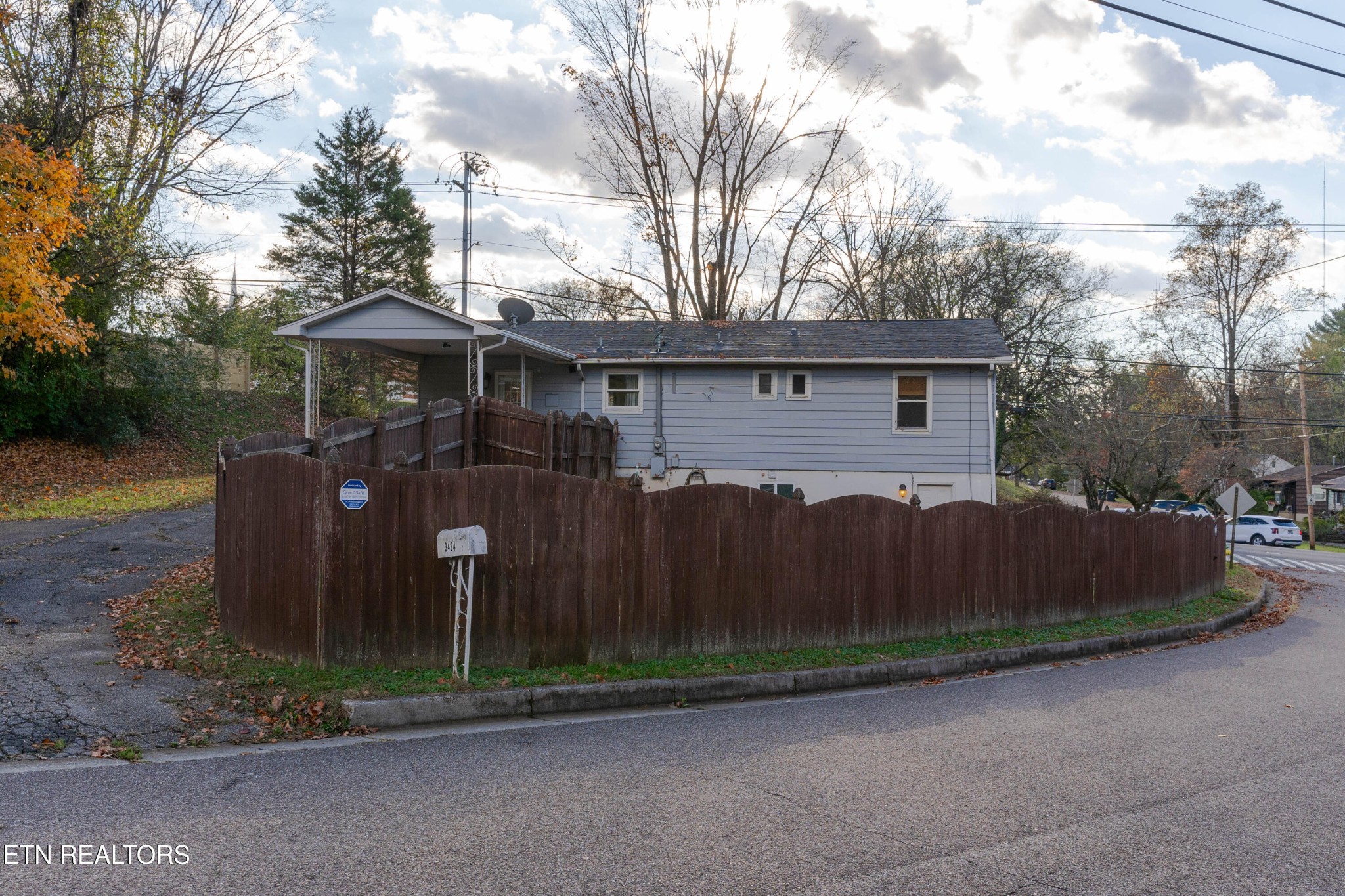 3424 Whittle Springs Road Knoxville, TN 37917 - Photo 26 of 29 a view of a house with a small yard and wooden fence