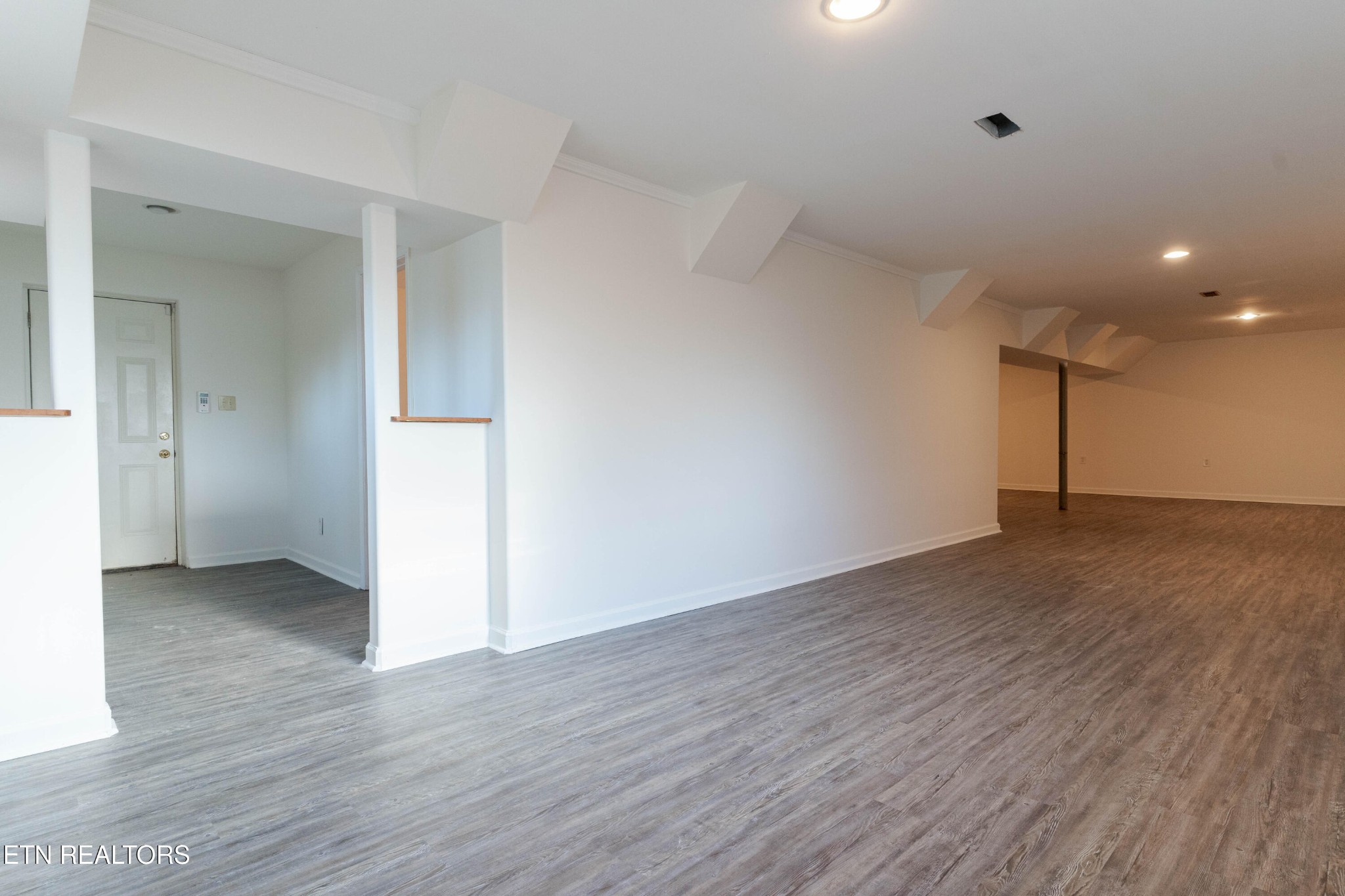 3424 Whittle Springs Road Knoxville, TN 37917 - Photo 4 of 29 a view of an empty room with wooden floor and closet