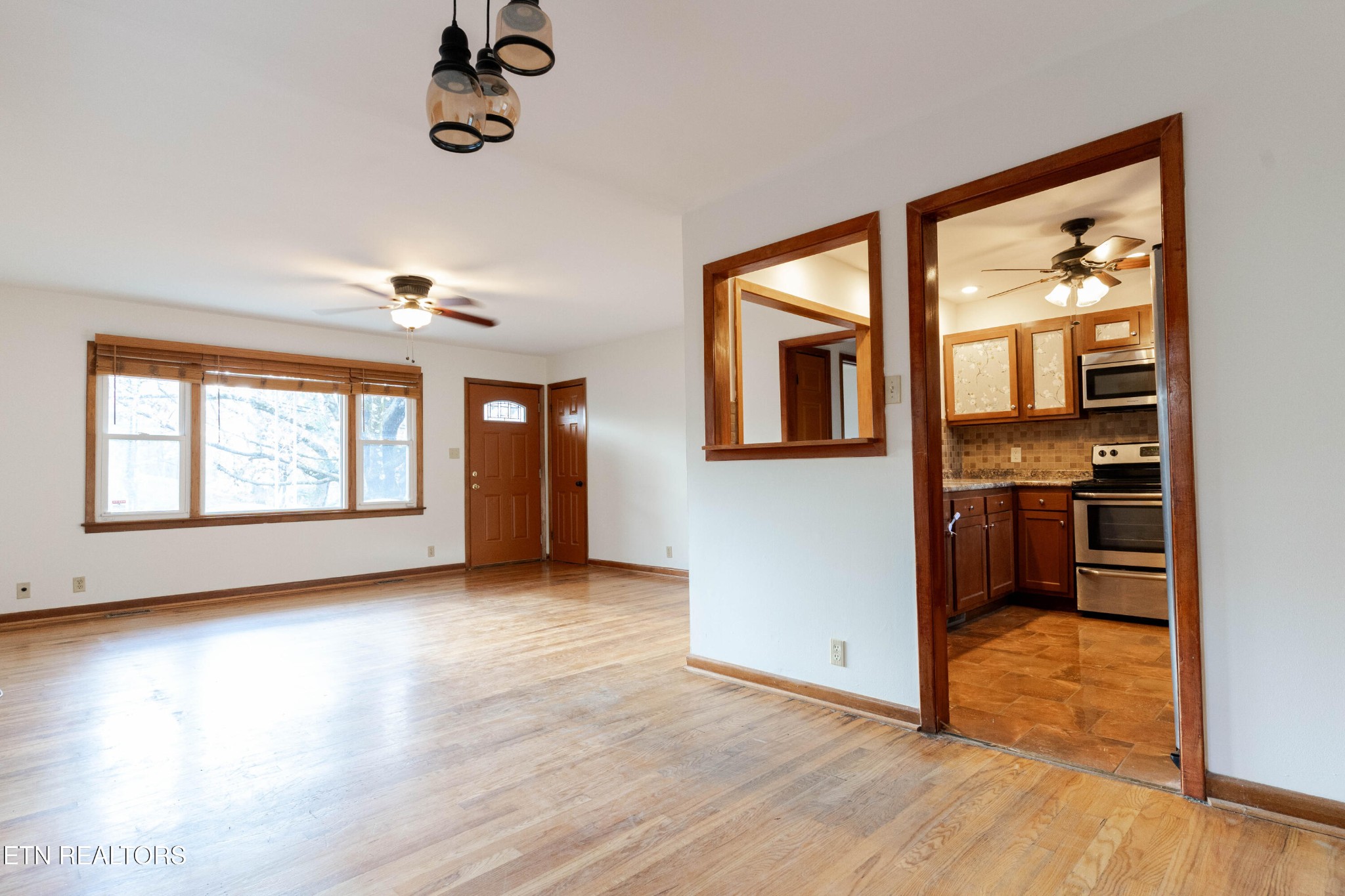 3424 Whittle Springs Road Knoxville, TN 37917 - Photo 5 of 29 an empty room with wooden floor and windows