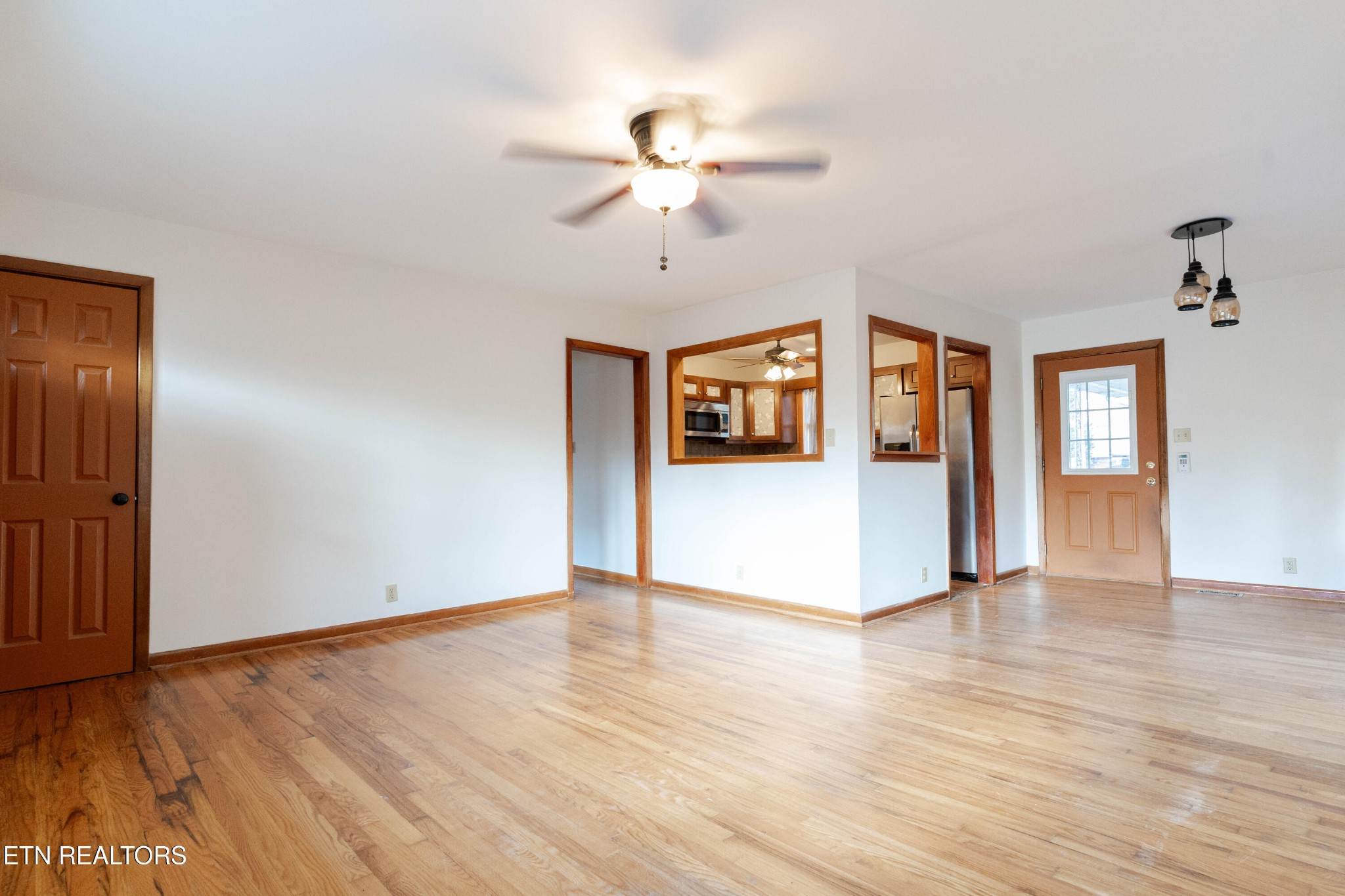 3424 Whittle Springs Road Knoxville, TN 37917 - Photo 6 of 29 a view of an empty room with window and wooden floor