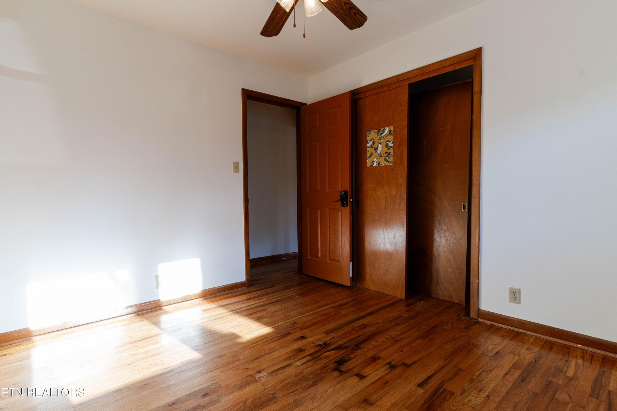 3424 Whittle Springs Road Knoxville, TN 37917 - Photo 9 of 29 a view of an empty room with window and wooden floor
