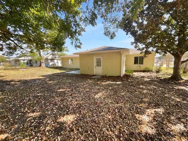 a front view of house with yard and trees around