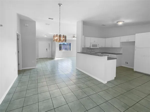 a kitchen with stainless steel appliances a refrigerator sink and cabinets
