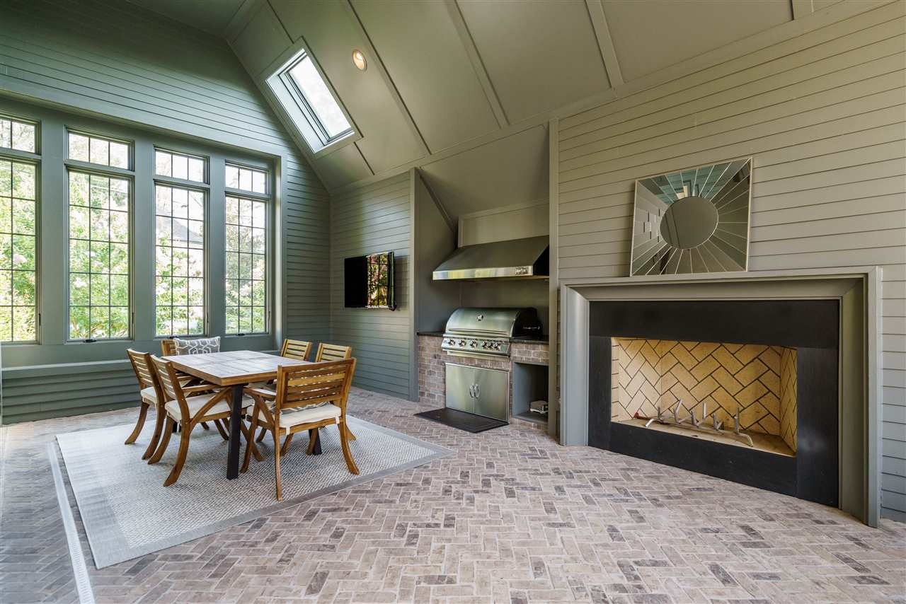 1346 Canterbury Road Raleigh, NC 27608 - Photo 26 of 30 One of the most expensive rooms in the home. Herringbone brick tile, word-burning fireplace, built-in gas grill with vented hood. Staircase leads to the garage below. Covered Veranda