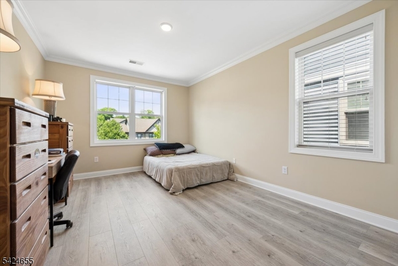 401 Mariners Pointe Hopatcong, NJ 07843 - Photo 27 of 42 a spacious bedroom with a bed and wooden floor