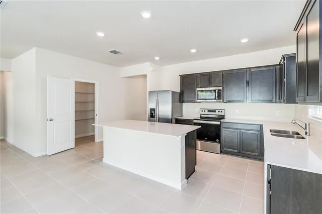 a kitchen with cabinets and stainless steel appliances