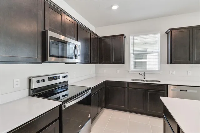 a kitchen that has a sink and a stove top oven