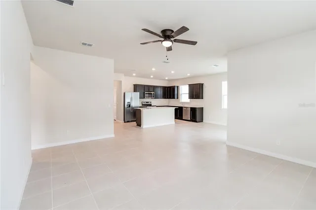 a view of a kitchen with a sink and stainless steel appliances