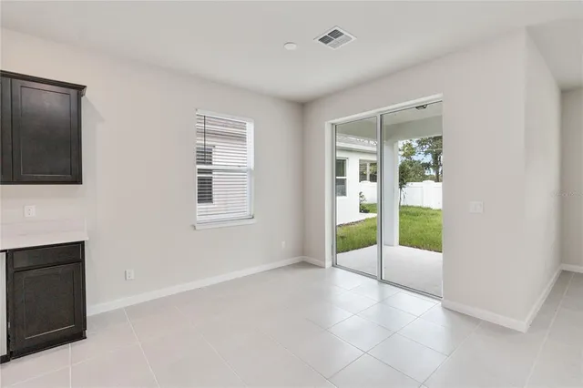 a view of an empty room with glass door