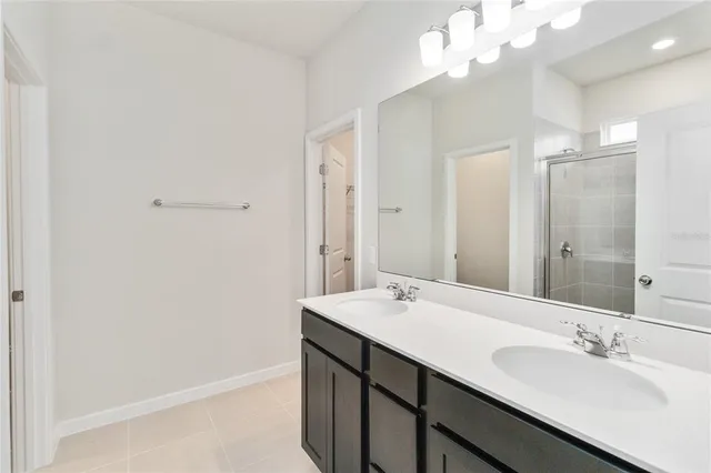 a bathroom with a sink a mirror and a shower