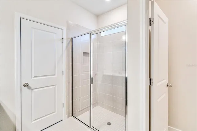a bathroom with a glass shower door