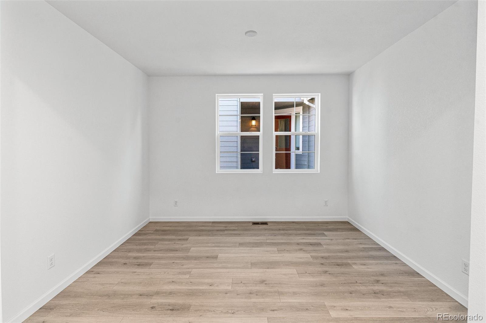23936 River Front Drive Aurora, CO 80019 - Photo 15 of 46 a view of empty room with wooden floor and fan
