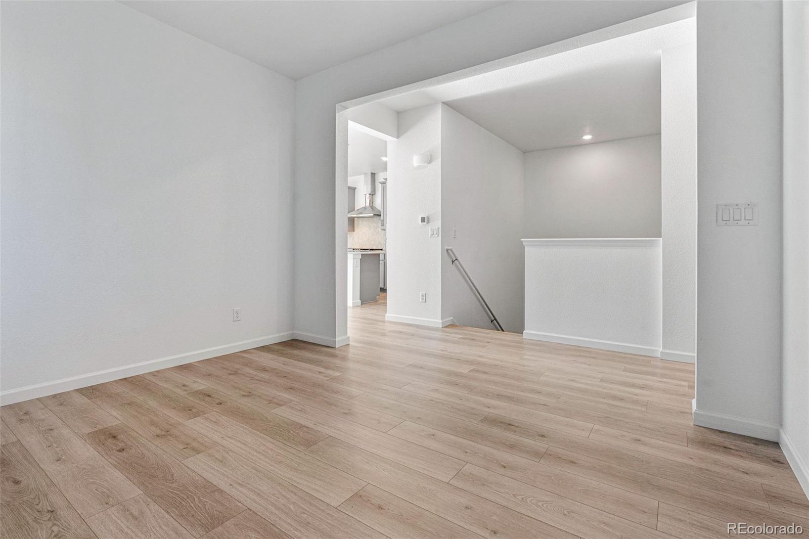 23936 River Front Drive Aurora, CO 80019 - Photo 16 of 46 a view of an empty room with wooden floor and a window