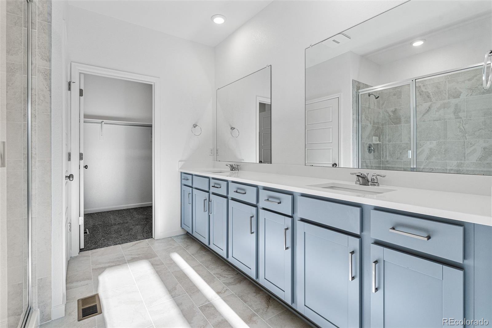 23936 River Front Drive Aurora, CO 80019 - Photo 26 of 46 a bathroom with a double vanity sink and mirror