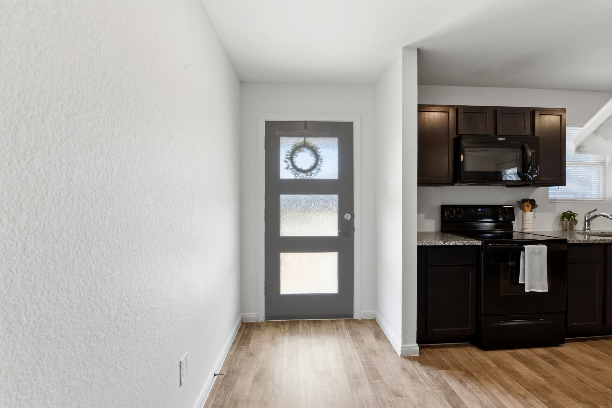 9819 Emerald Stone Way Conroe, TX 77306 - Photo 5 of 38 a kitchen with a refrigerator and a stove top oven