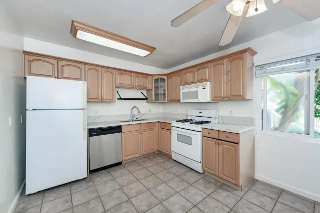 a kitchen with granite countertop cabinets stainless steel appliances and a island