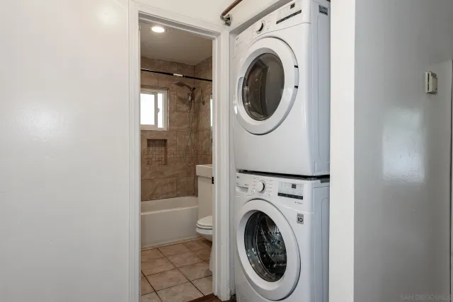 a view of a hallway with washer and dryer
