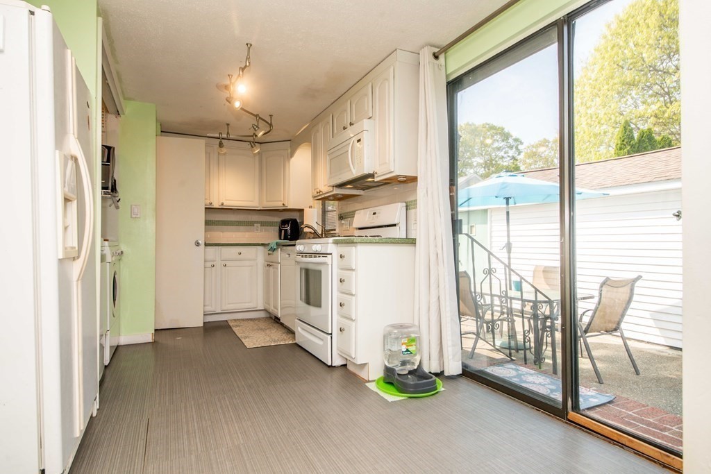 9 Grant Street Wareham, MA 02571 - Photo 8 of 18 a kitchen with white cabinets and white appliances